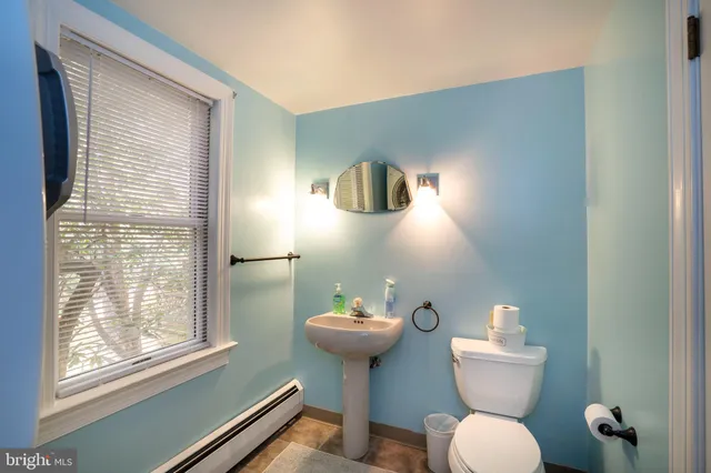 a bedroom with two beds and potted plant