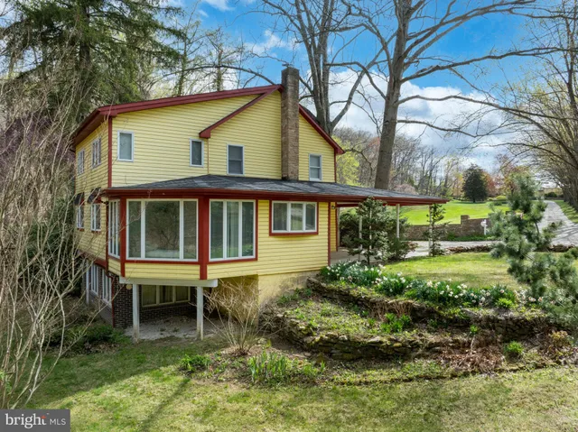 an aerial view of residential house and car parked