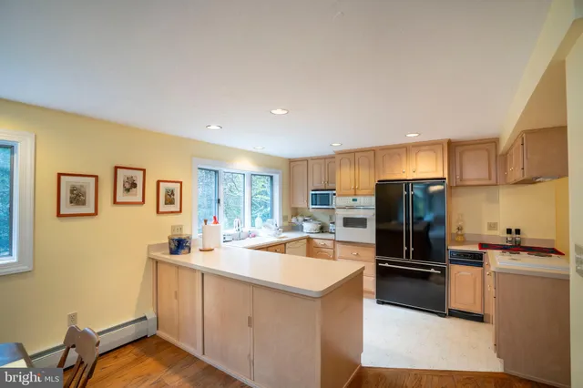 a kitchen that has a sink cabinets counter space and stainless steel appliances