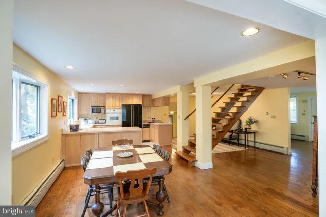 a view of a dining room with furniture and wooden floor