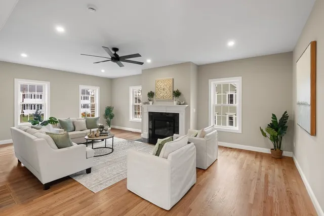 a living room with furniture fireplace and window