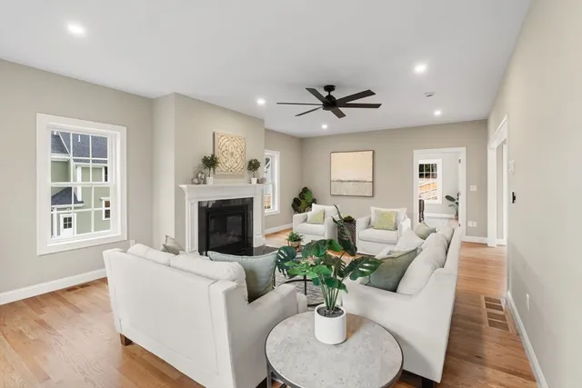 a living room with furniture potted plant and a fireplace