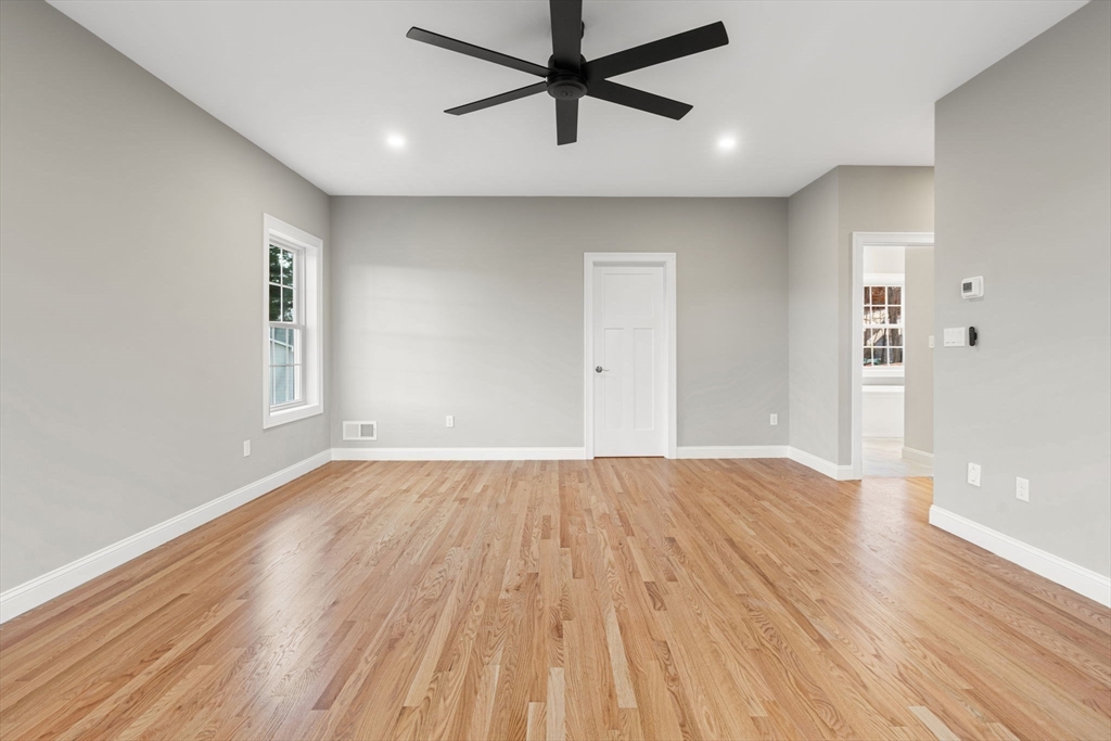 103 Central Street Andover, MA 01810 - Photo 27 of 42 an empty room with wooden floor and windows