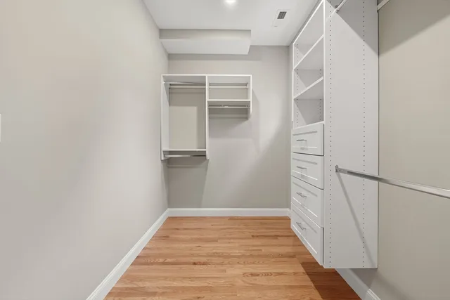 a view of a hallway with wooden floor and entryway