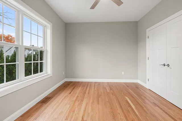 a view of a room with wooden floor and windows