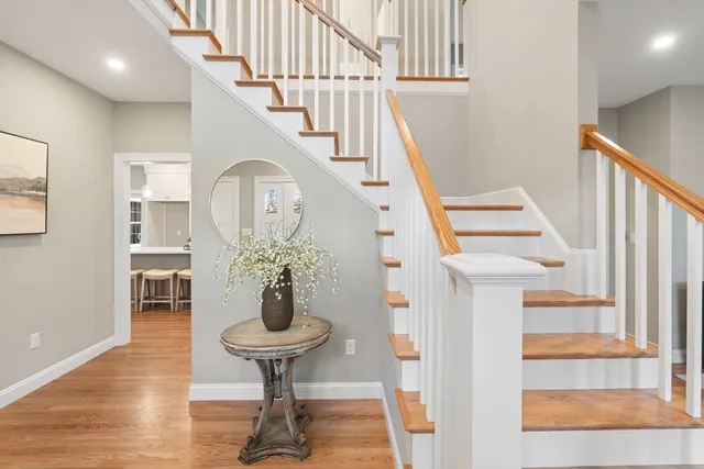 a view of entryway and hall with wooden floor