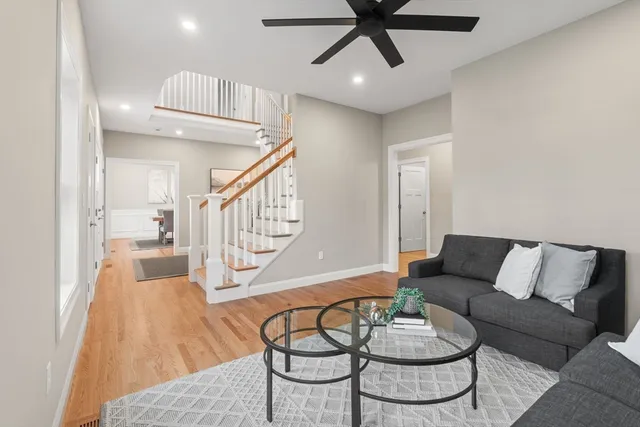 a living room with furniture and a wooden floor