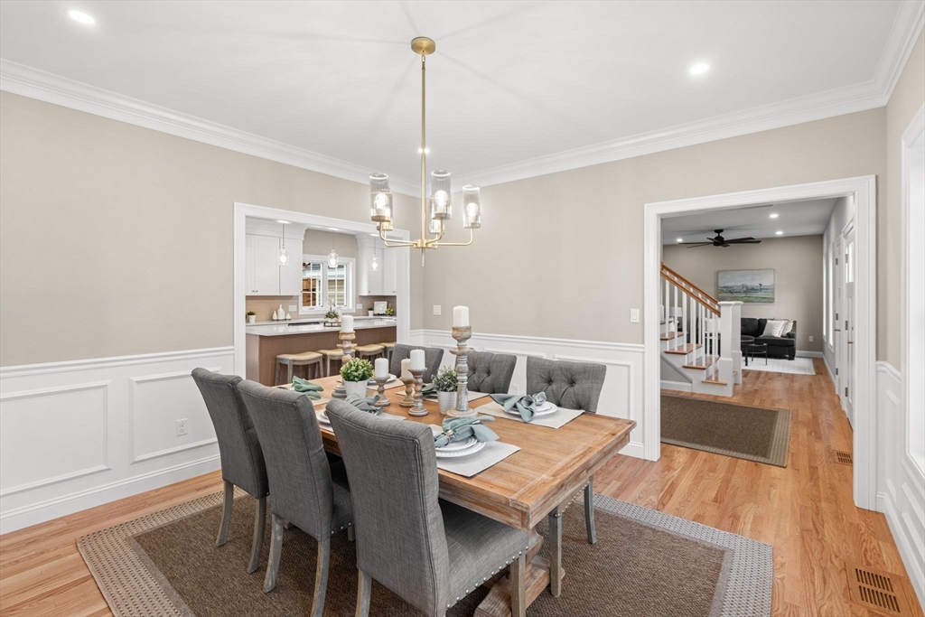 103 Central Street Andover, MA 01810 - Photo 8 of 42 a dining room with furniture a chandelier and wooden floor
