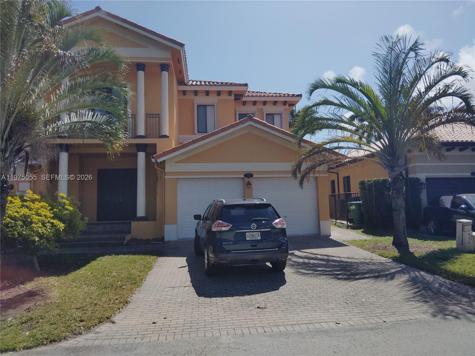 a front view of a house with a garden