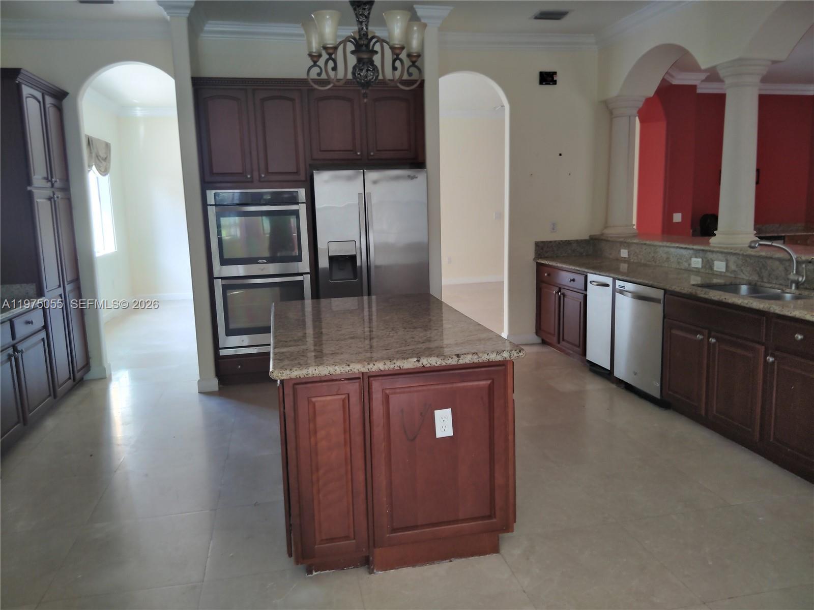 7944 Southwest 194th Street Cutler Bay, FL 33157 - Photo 2 of 10 a kitchen with stainless steel appliances granite countertop a stove a refrigerator and a wooden cabinets