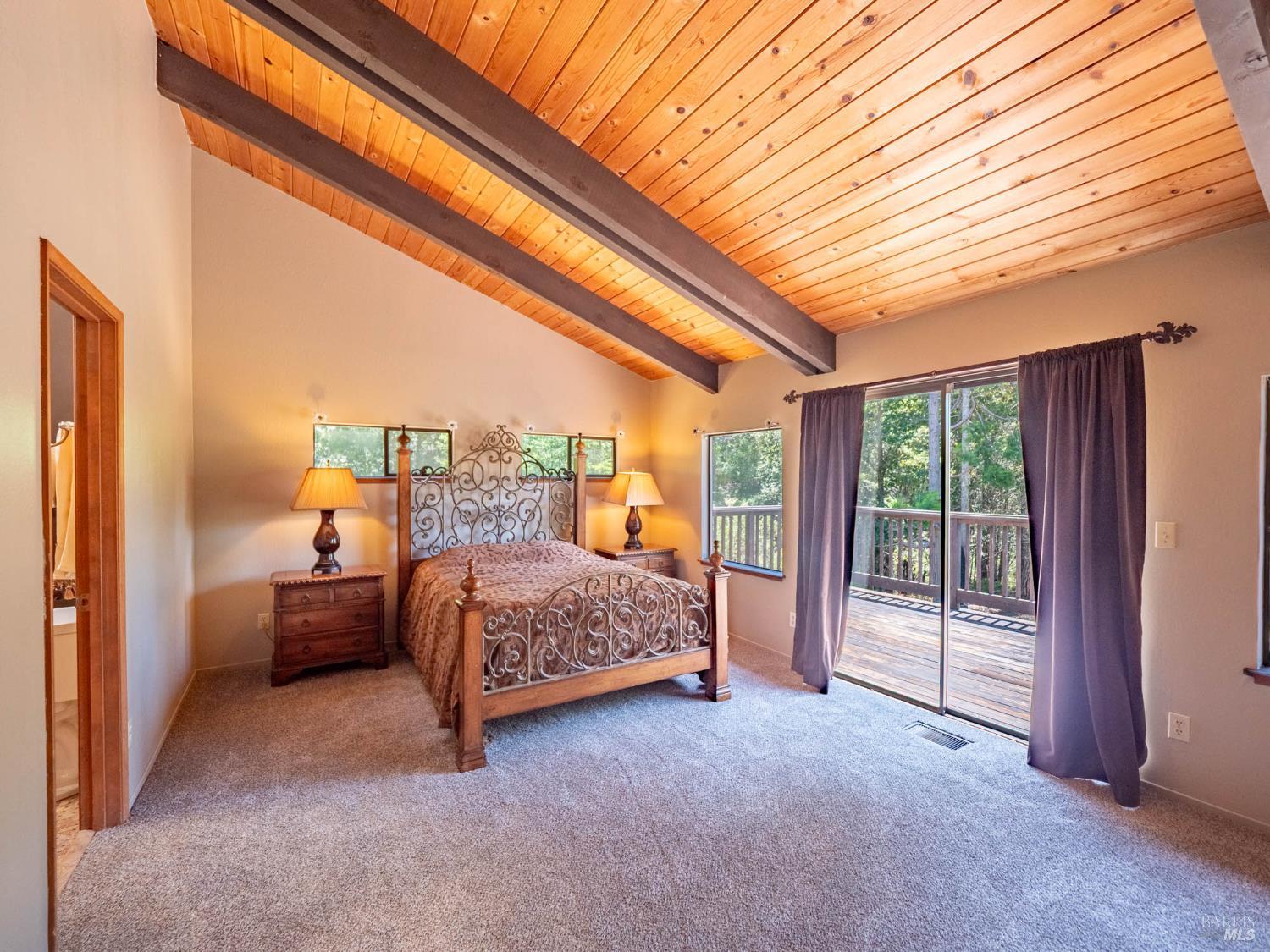 7701 Signal Ridge Road Philo, CA 95466 - Photo 13 of 32 The beautiful Primary Suite with sliding door to a private deck area.