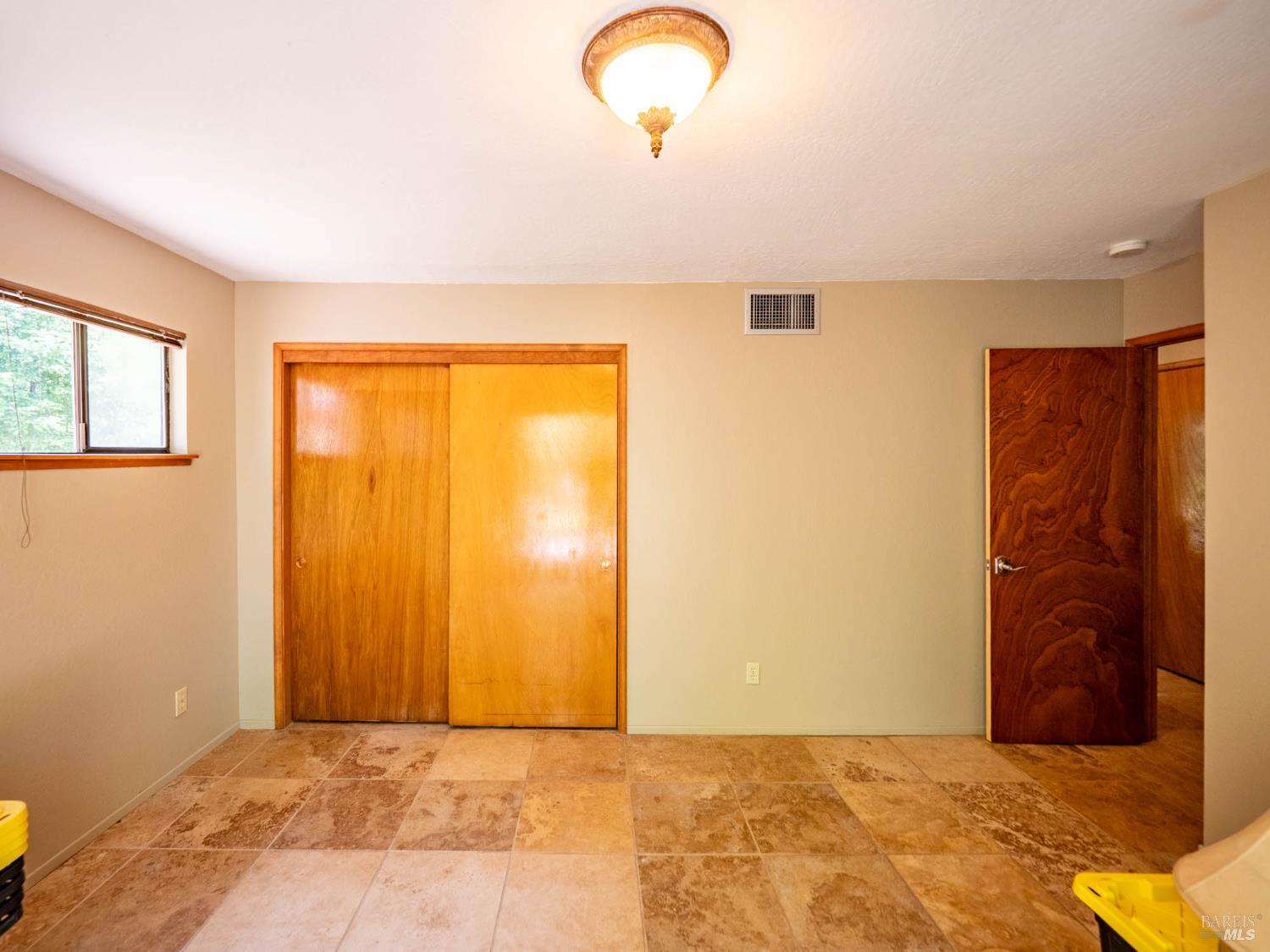 7701 Signal Ridge Road Philo, CA 95466 - Photo 18 of 32 The second spacious bedroom on the lower level. This room also offers private outdoor access via a sliding glass door.