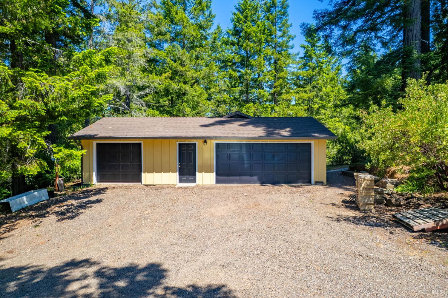 7701 Signal Ridge Road Philo, CA 95466 - Photo 22 of 32 There are 2 garage spaces, each with its own door. One is an oversized 2 car garage space, the other is a single car space. The workshop/game room sits behind the garage space. The garage is on a cement slab and the drywall is finished.