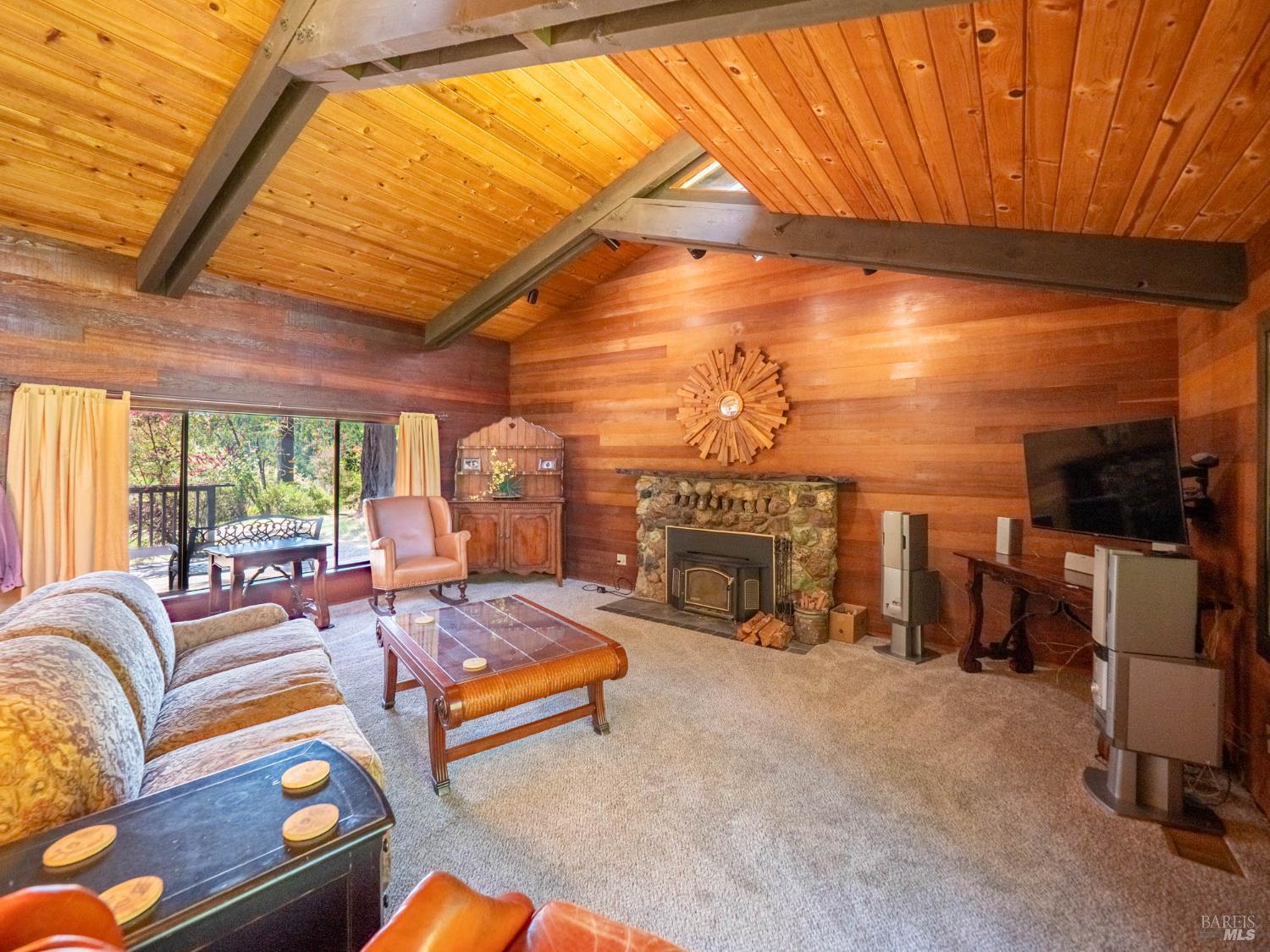 7701 Signal Ridge Road Philo, CA 95466 - Photo 4 of 32 The Living Room has a beautiful stone fireplace complimented by the lovely wood interior.