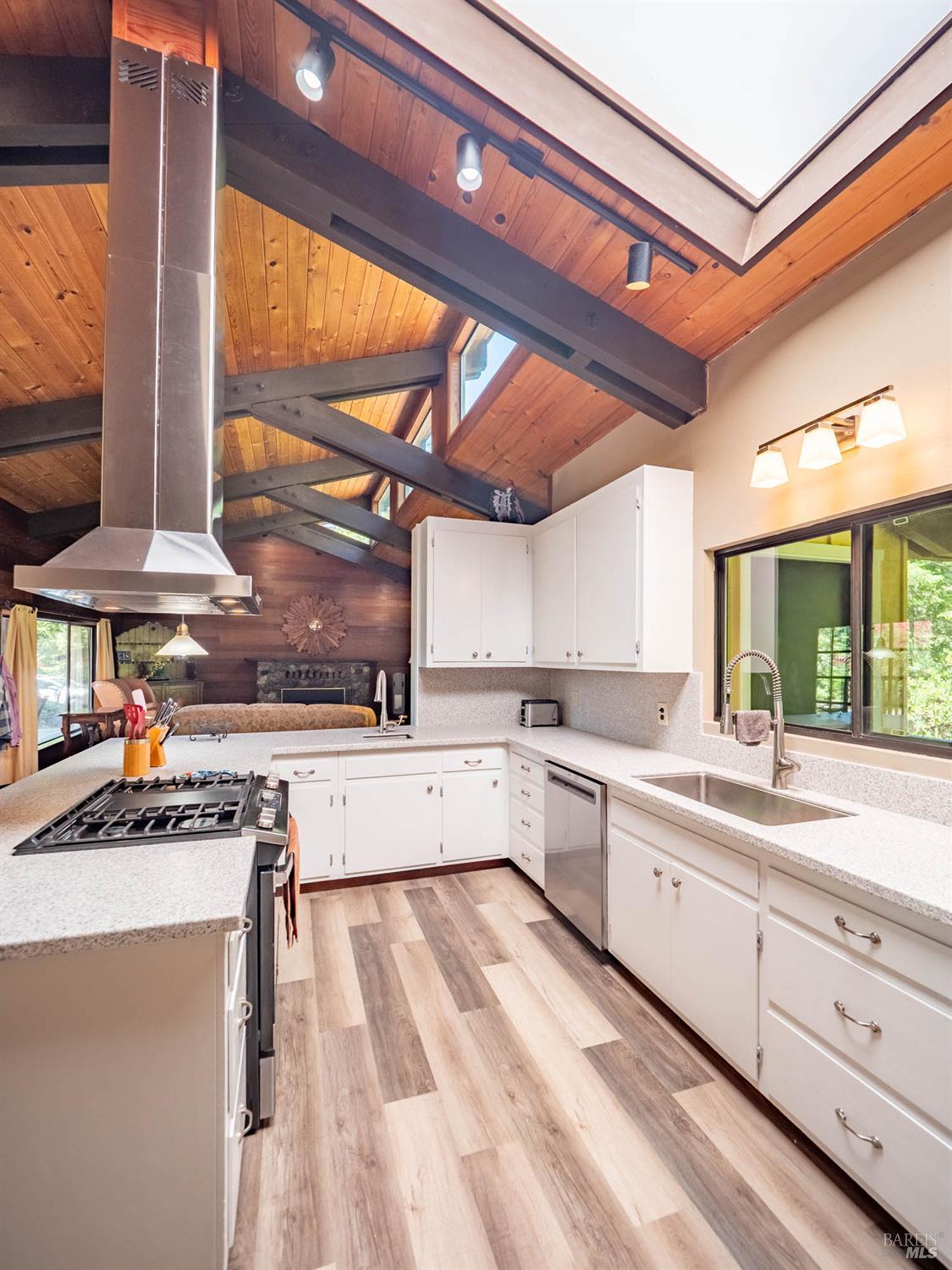 7701 Signal Ridge Road Philo, CA 95466 - Photo 8 of 32 Completely Renovated Kitchen with newly painted cabinetry, solid surface countertops, high-end appliances and an island stove with freestanding hood.