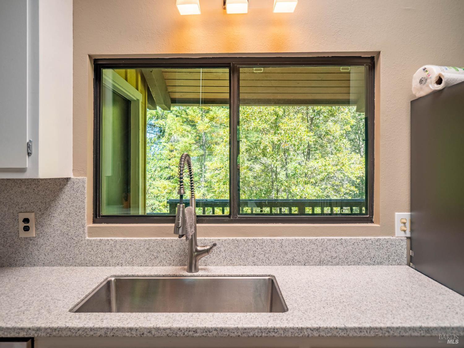 7701 Signal Ridge Road Philo, CA 95466 - Photo 9 of 32 Lovely, new, enlarged kitchen window looks over the covered porch to the beautiful trees beyond.