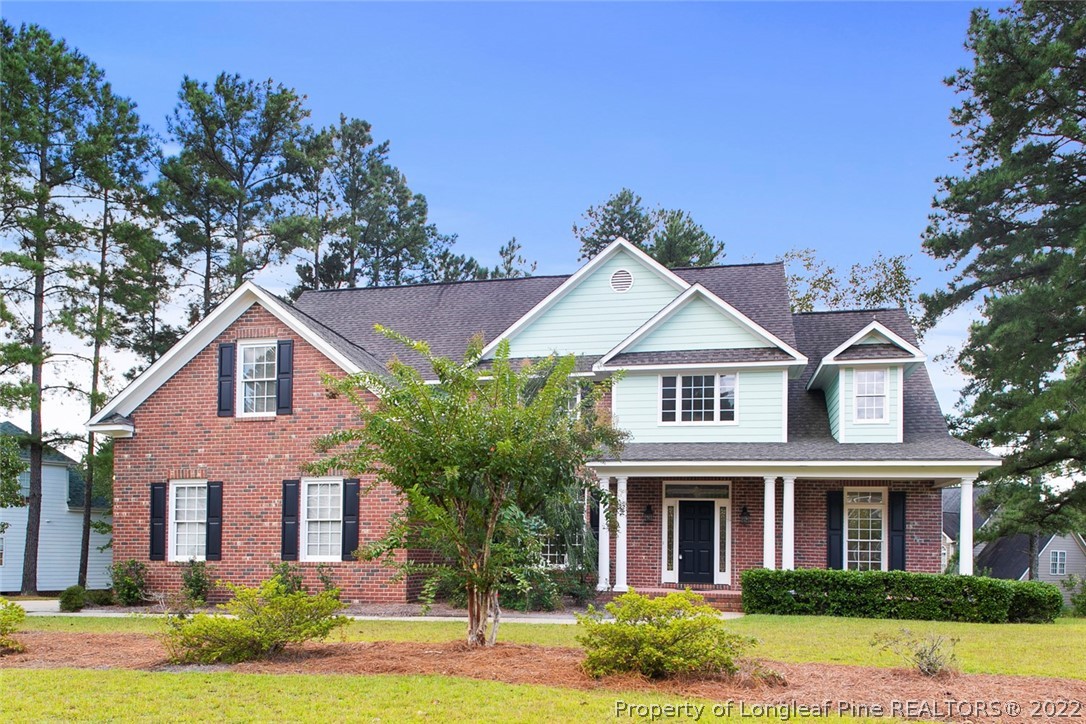 front view of brick house with a yard