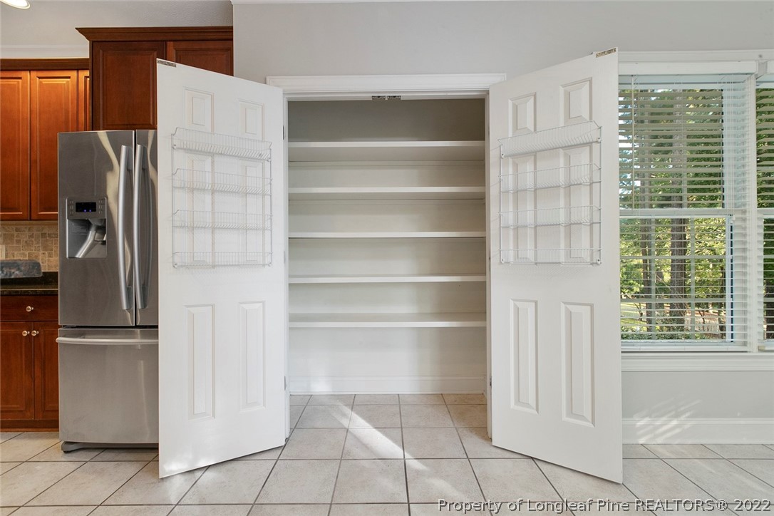 480 Whispering Pines Drive Spring Lake, NC 28390 - Photo 14 of 48 a view of walk in closet with empty racks