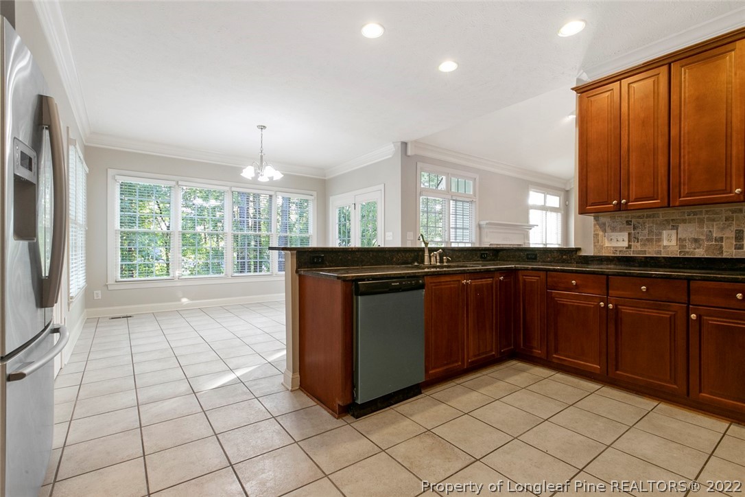 480 Whispering Pines Drive Spring Lake, NC 28390 - Photo 16 of 48 a kitchen with a sink a counter top space and cabinets