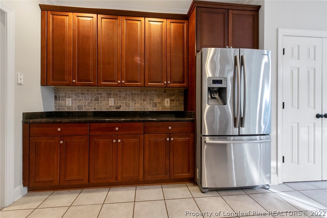 480 Whispering Pines Drive Spring Lake, NC 28390 - Photo 19 of 48 a kitchen with stainless steel appliances granite countertop a refrigerator and a sink