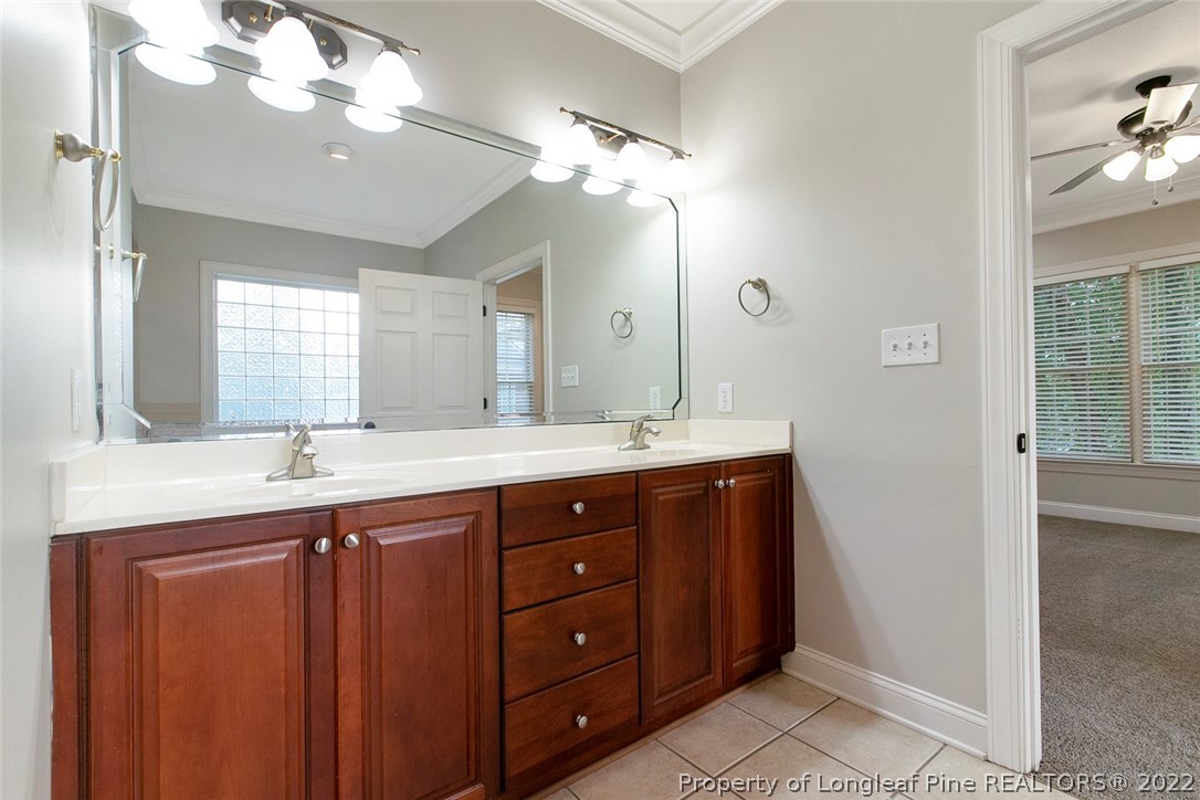 480 Whispering Pines Drive Spring Lake, NC 28390 - Photo 28 of 48 a bathroom with a granite countertop sink a light fixture and a mirror