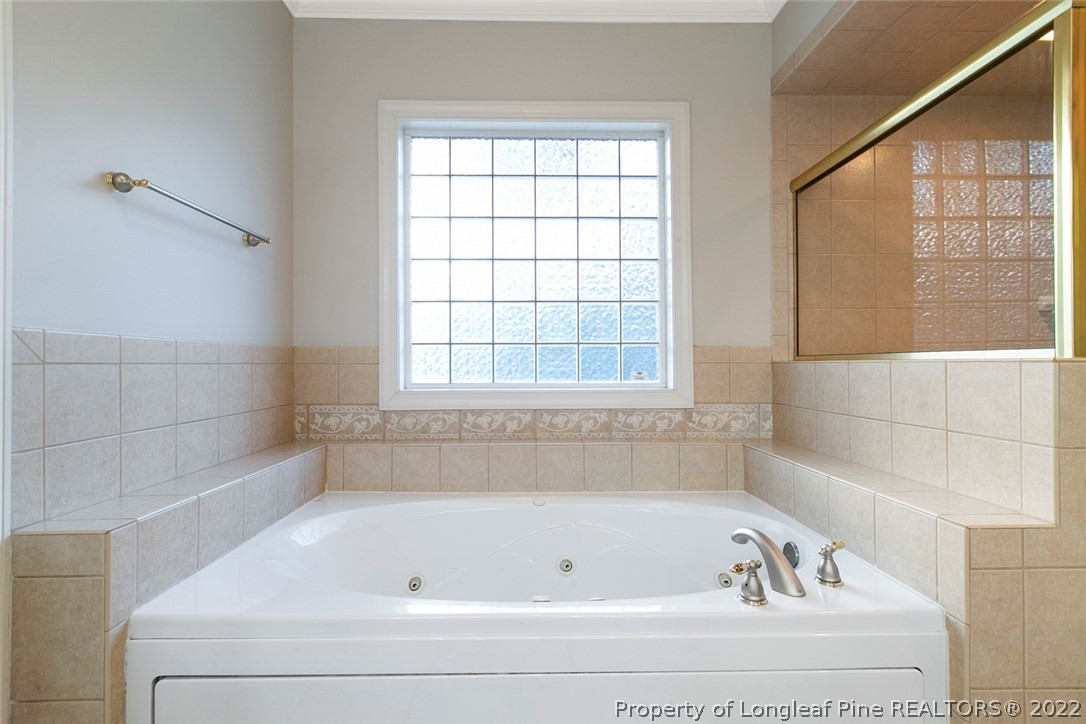 480 Whispering Pines Drive Spring Lake, NC 28390 - Photo 29 of 48 a bathroom with a bathtub