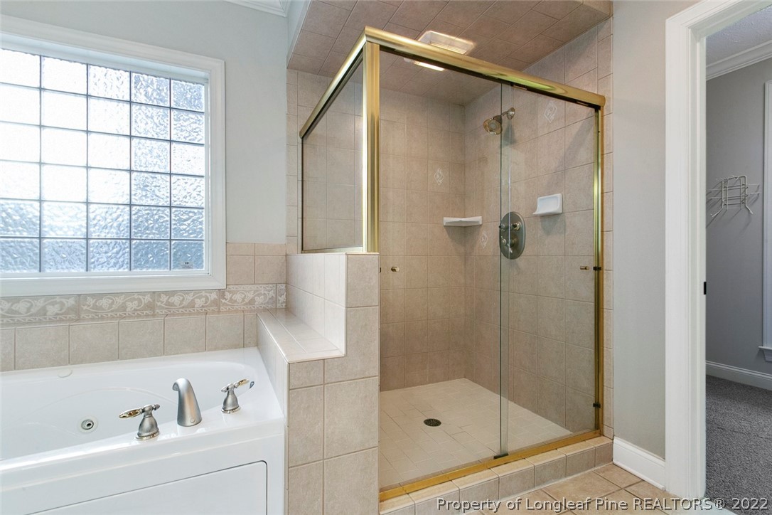 480 Whispering Pines Drive Spring Lake, NC 28390 - Photo 30 of 48 a bathroom with a shower and a bathtub