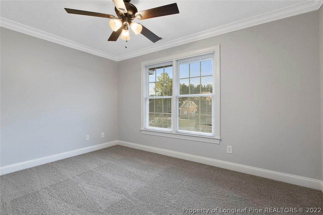 480 Whispering Pines Drive Spring Lake, NC 28390 - Photo 35 of 48 an empty room with a window and a fan