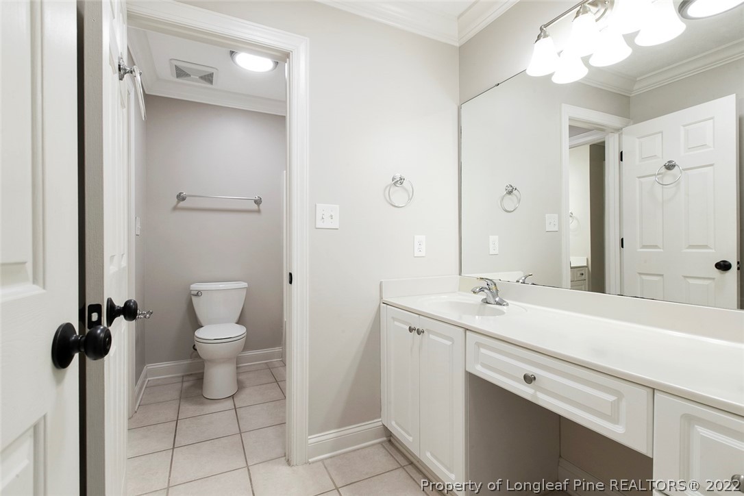 480 Whispering Pines Drive Spring Lake, NC 28390 - Photo 37 of 48 a bathroom with a sink a toilet and a mirror