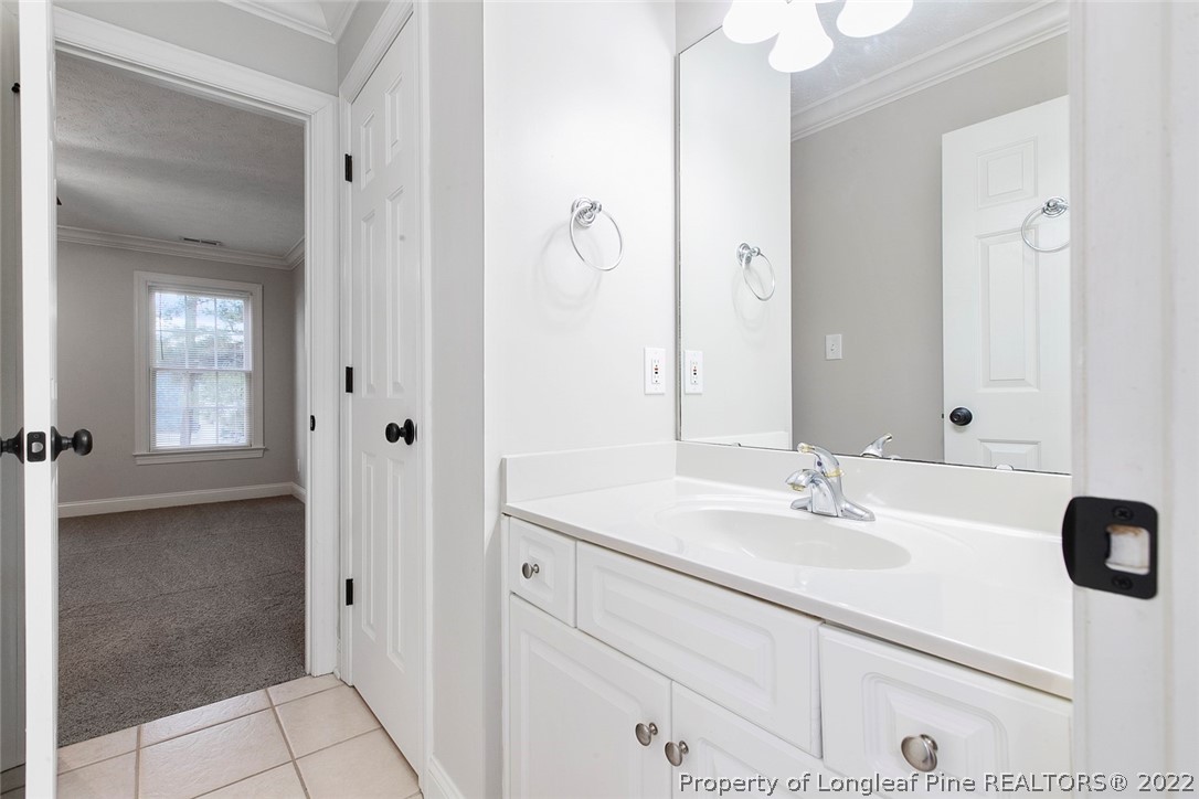 480 Whispering Pines Drive Spring Lake, NC 28390 - Photo 38 of 48 a bathroom with a sink and a mirror