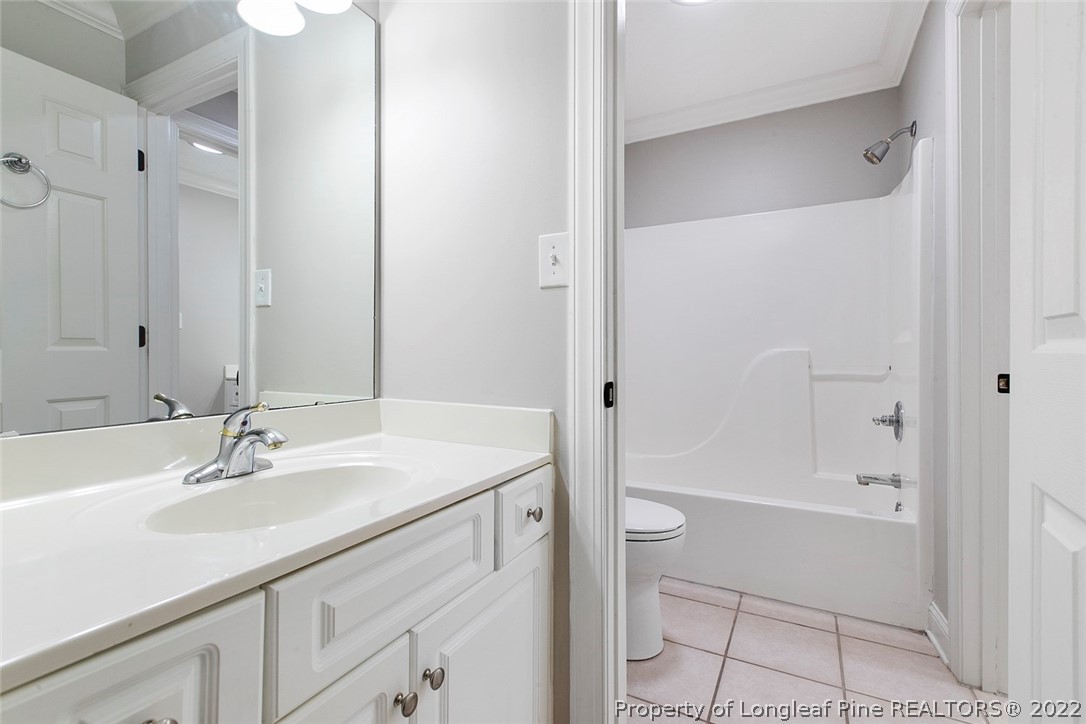 480 Whispering Pines Drive Spring Lake, NC 28390 - Photo 39 of 48 a bathroom with a sink a toilet and shower