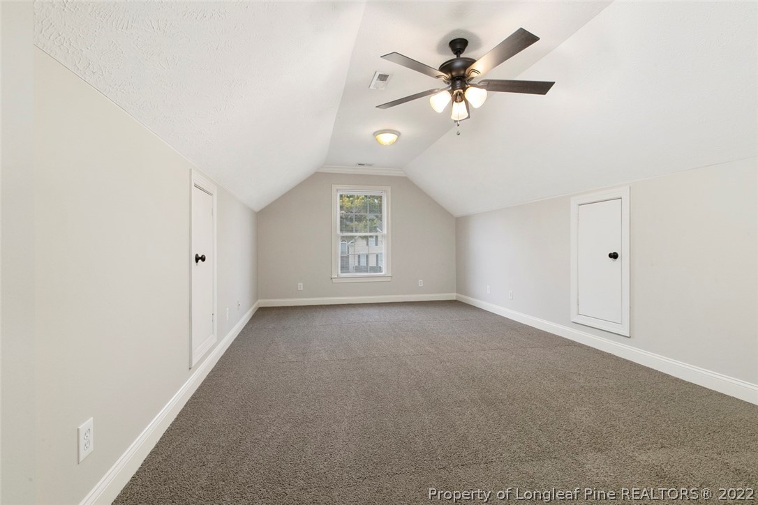 480 Whispering Pines Drive Spring Lake, NC 28390 - Photo 42 of 48 an empty room with chandelier fan and windows