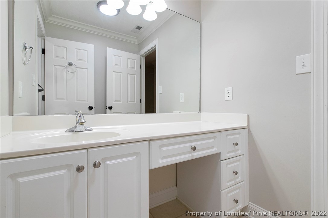 480 Whispering Pines Drive Spring Lake, NC 28390 - Photo 44 of 48 a bathroom with a sink and a mirror