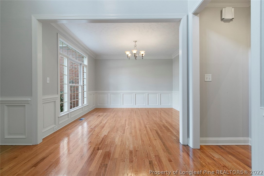 480 Whispering Pines Drive Spring Lake, NC 28390 - Photo 7 of 48 a view of an empty room with wooden floor and a window