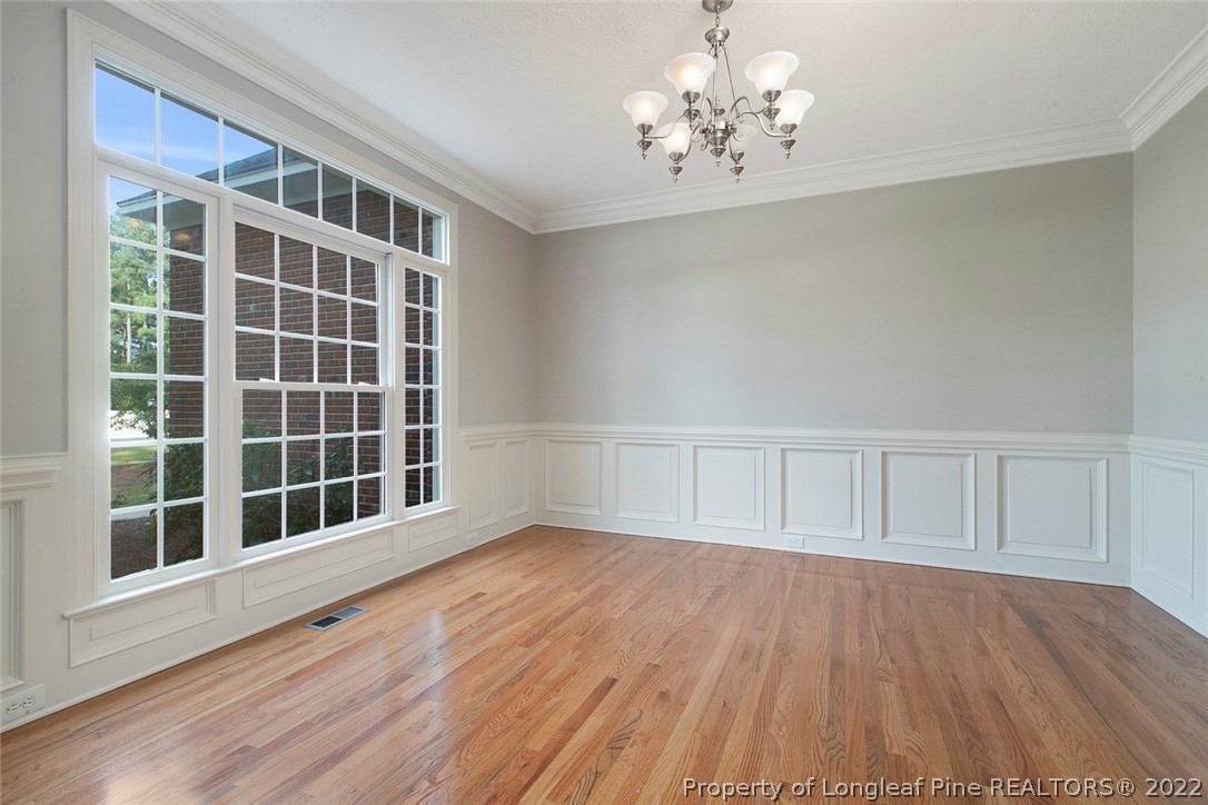 480 Whispering Pines Drive Spring Lake, NC 28390 - Photo 8 of 48 a view of an empty room with wooden floor and a window
