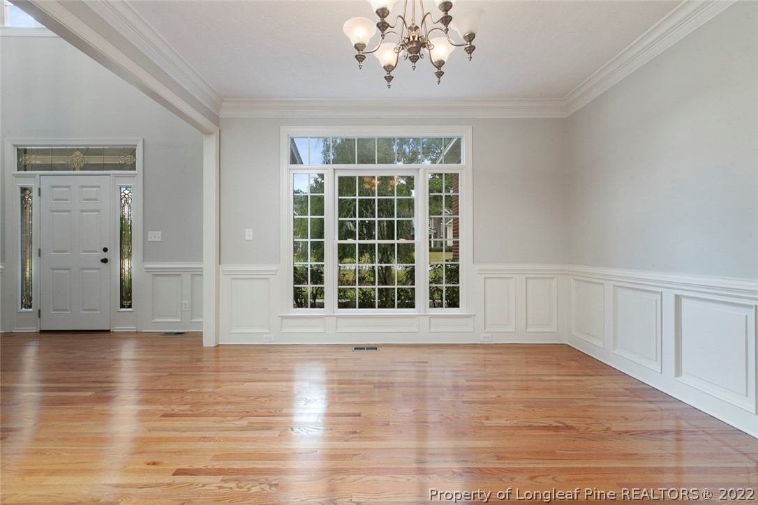 480 Whispering Pines Drive Spring Lake, NC 28390 - Photo 9 of 48 a view of an empty room with wooden floor and a window