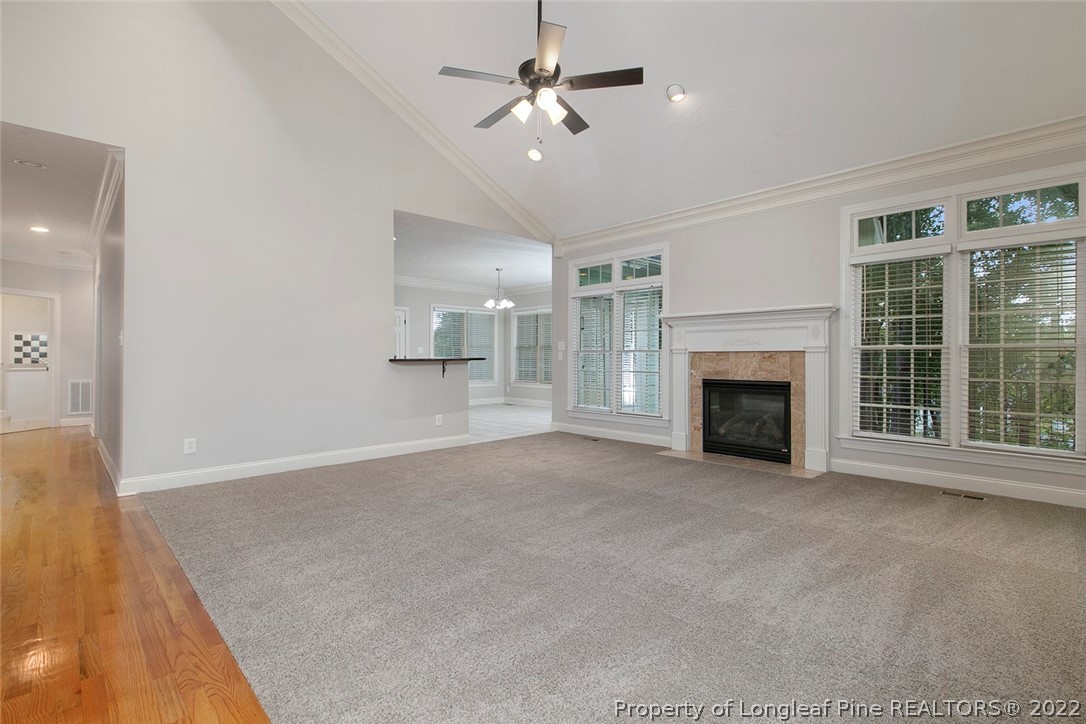 480 Whispering Pines Drive Spring Lake, NC 28390 - Photo 10 of 48 a view of empty room with fireplace and fan