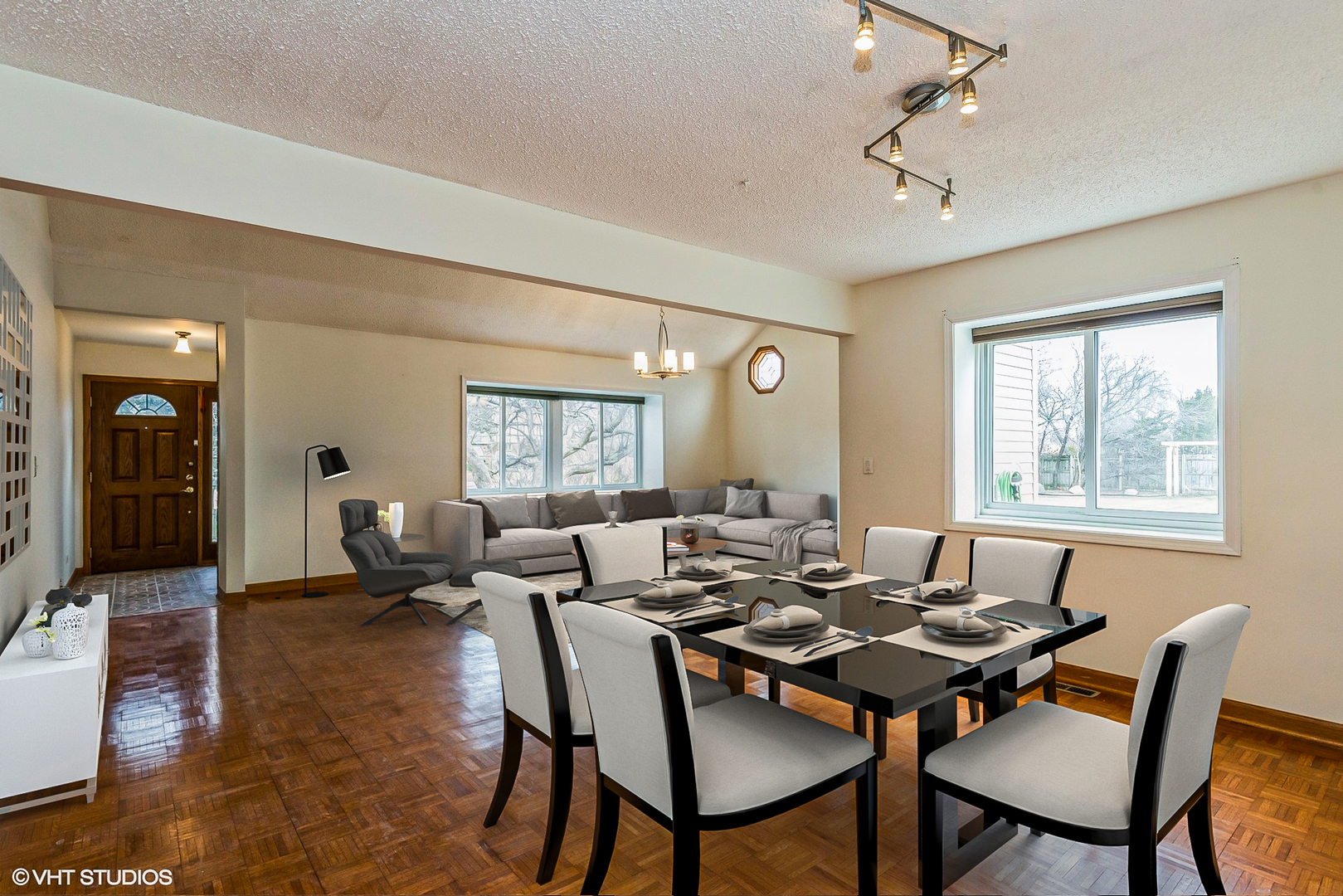 329 Killdeer Road Bloomingdale, IL 60108 - Photo 5 of 31 a dining room with wooden floor a chandelier a wooden table and chairs