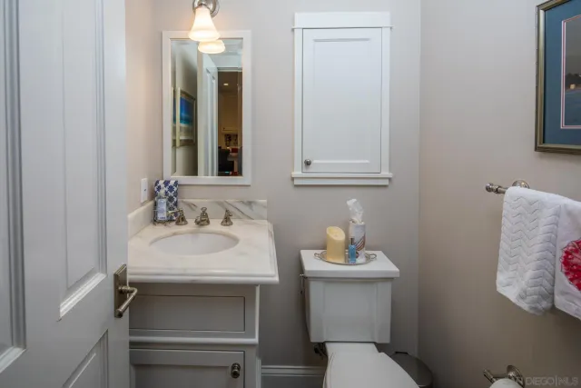a bathroom with a sink toilet and mirror
