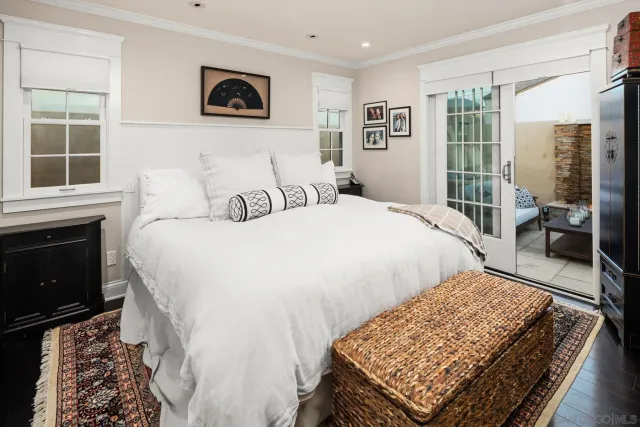 a bed sitting in a bedroom next to a window