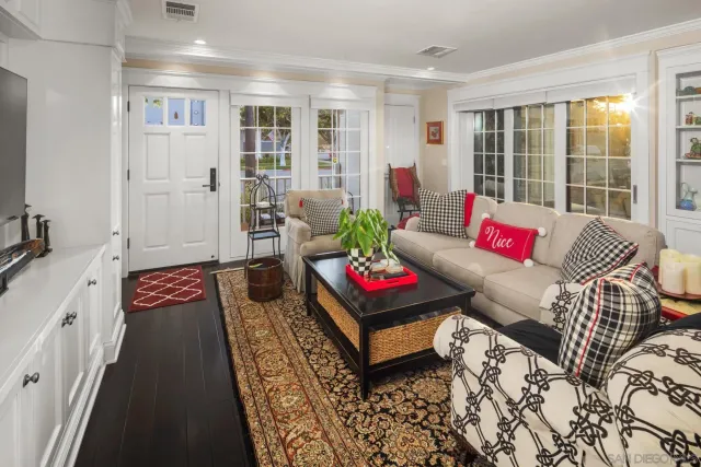 a living room with furniture and a floor to ceiling window