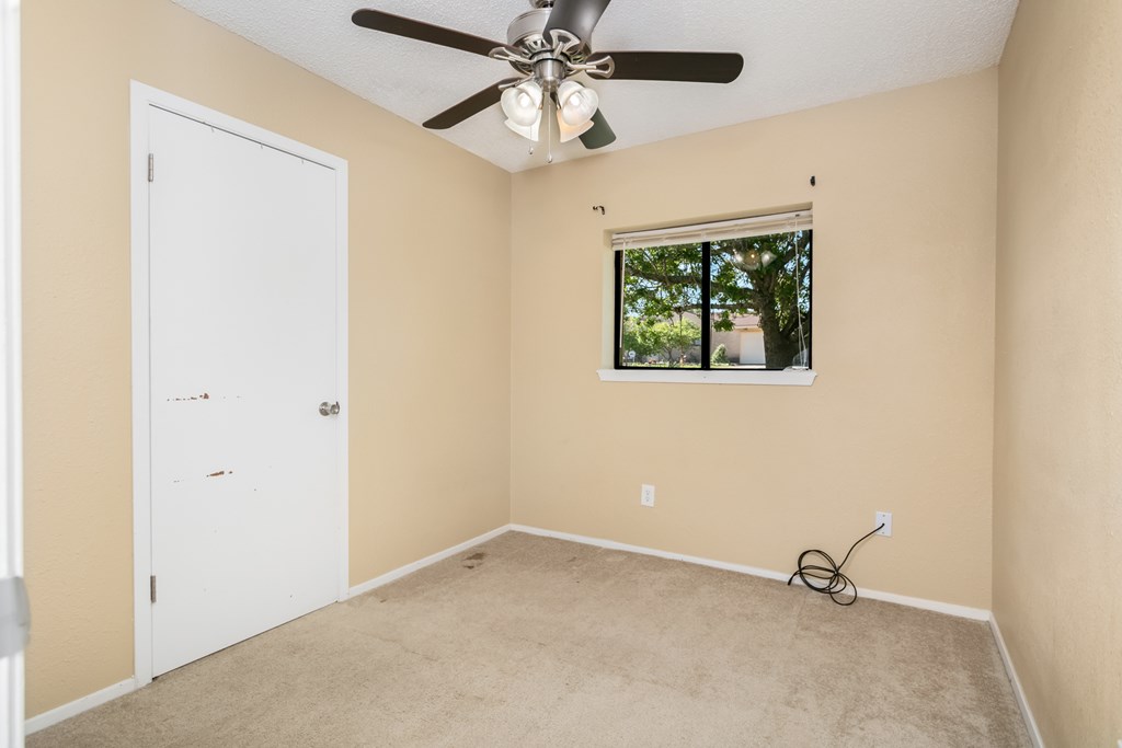 90 Quail Run Harper, TX 78631 - Photo 11 of 25 an empty room with windows and fan