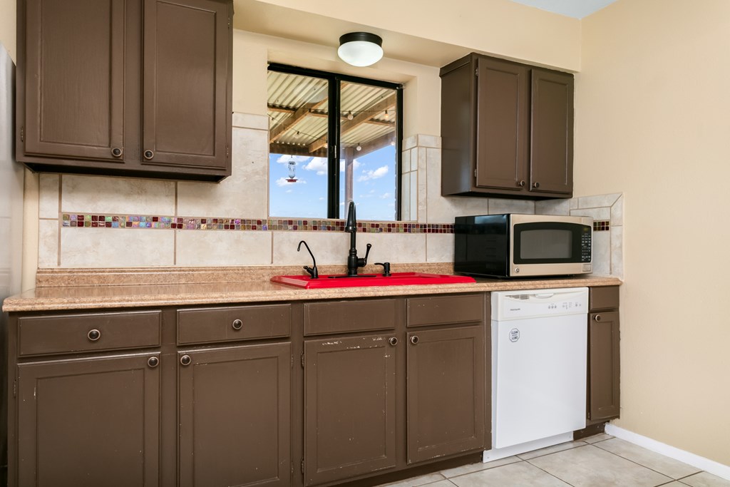 90 Quail Run Harper, TX 78631 - Photo 7 of 25 a kitchen with a sink cabinets and a microwave oven