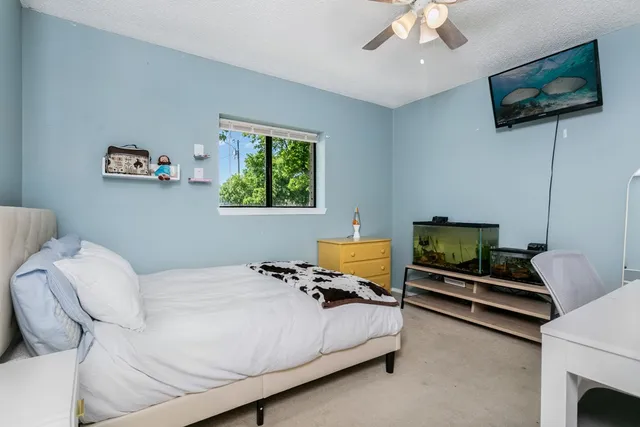 a bedroom with a bed and a television