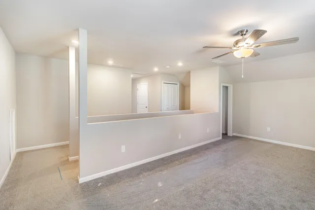 a view of an empty room with a fan