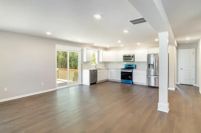 a view of a kitchen with a sink and a stove top oven