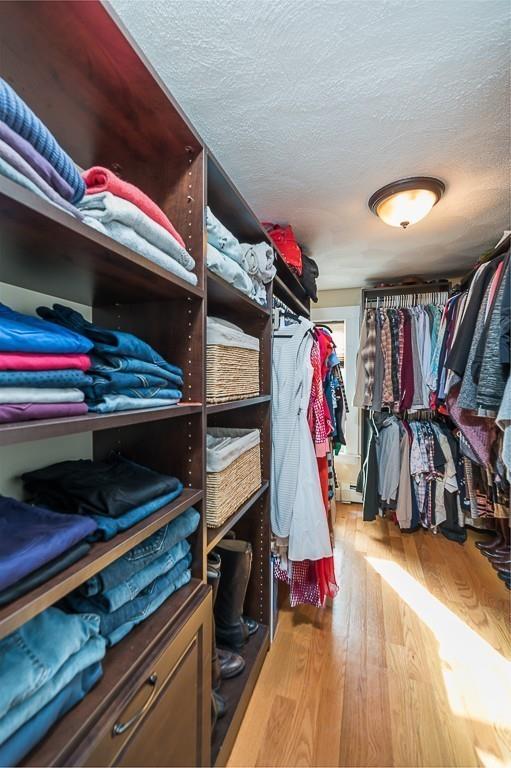 16 Bartlett Street Beverly, MA 01915 - Photo 13 of 28 a view of walk in closet with clothes and shoes