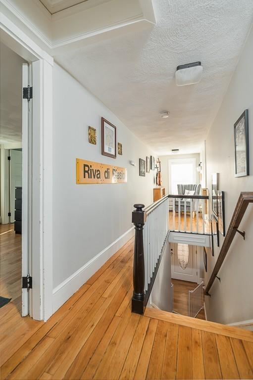 16 Bartlett Street Beverly, MA 01915 - Photo 15 of 28 a view of a living room and kitchen with wooden floor