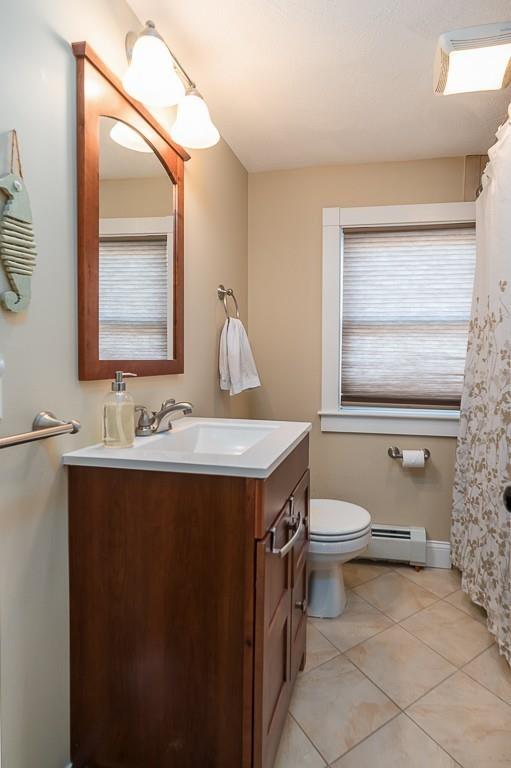 16 Bartlett Street Beverly, MA 01915 - Photo 18 of 28 a bathroom with a sink toilet and mirror