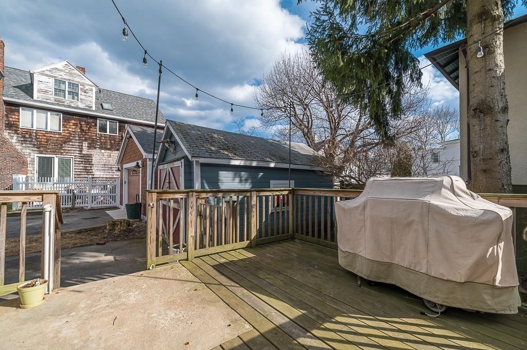 16 Bartlett Street Beverly, MA 01915 - Photo 25 of 28 a white house with a large tree in front of it